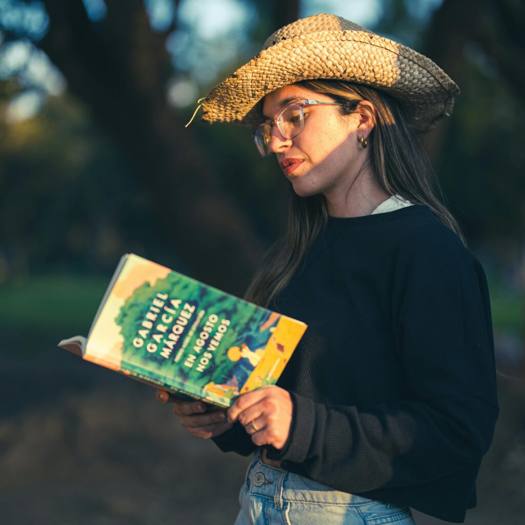 Woman in a hut reading book from Gabriel García Márquez