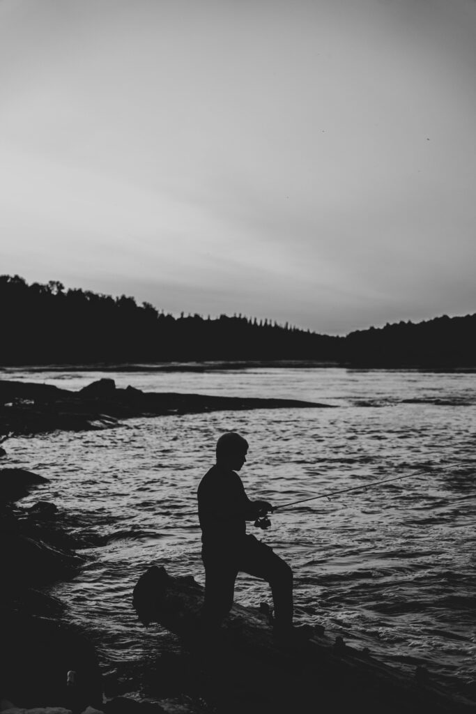 Silhouette of Man Fishing on the Shore